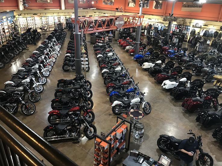 Rows of motorcycles lined up in a showroom before shipment